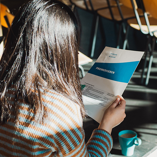 Tag für Promotionsinteressierte der Hamburg Research Academy: Eine Teilnehmerin schaut auf das Programm.